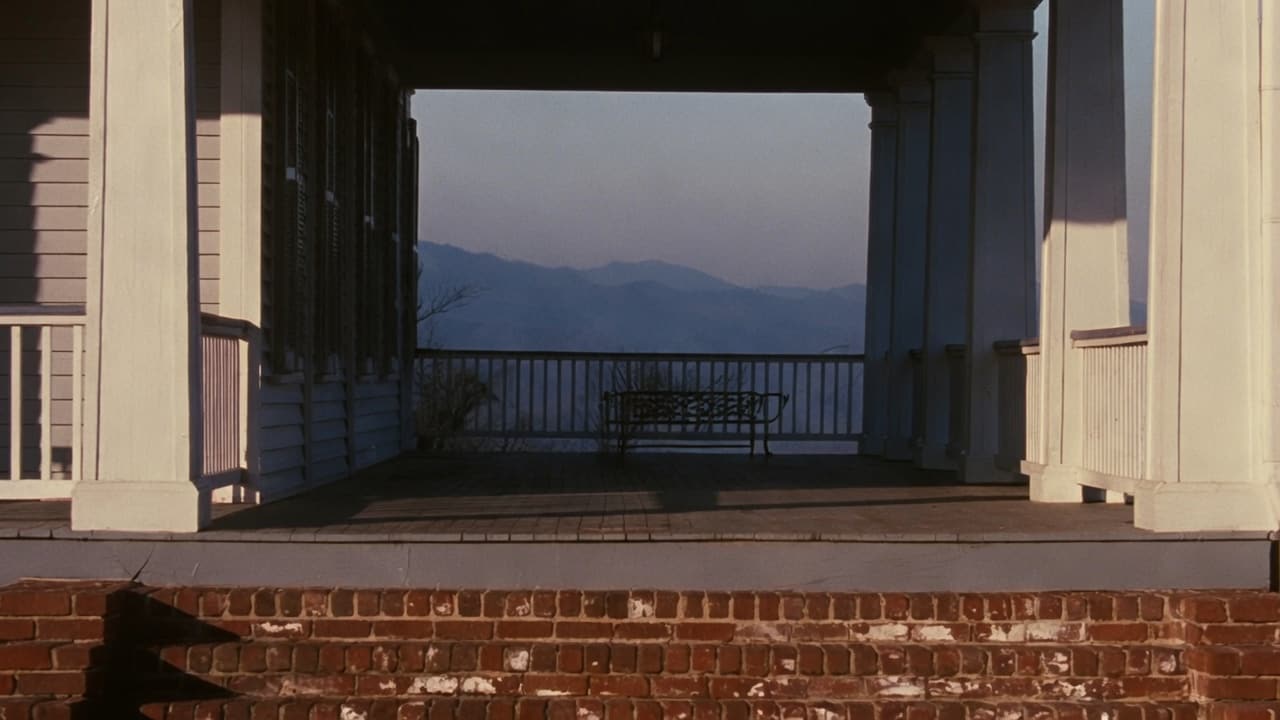 A porch looking out over a valley at blue hour.
